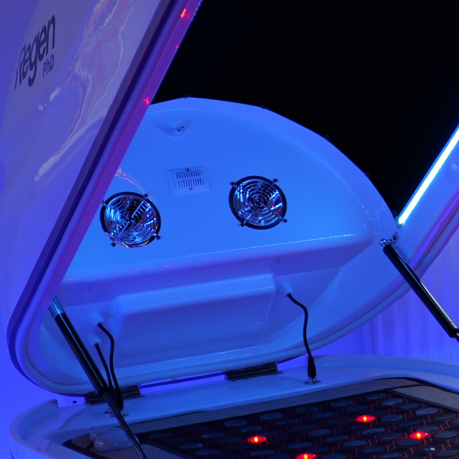 Inside the raised Regen Pod canopy showing two circular fans and a vent grille