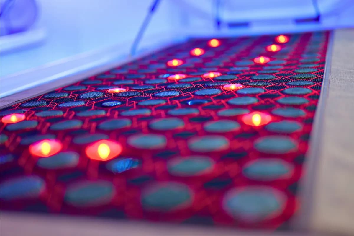 Close-up of the Regen Pod jade-stone bed with red light emitters between the stones